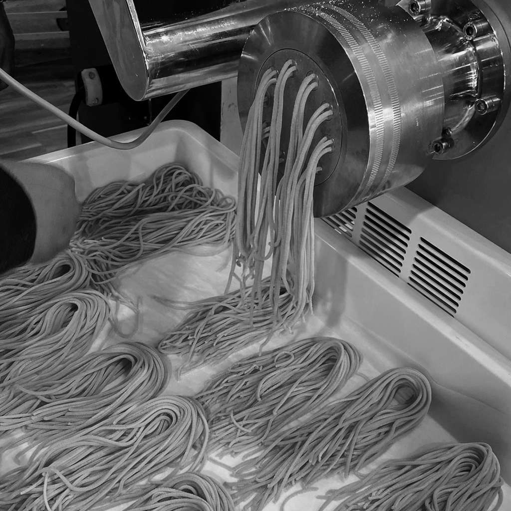 Black and white photo of ZIMI Italian Restaurant's homemade pasta machine.