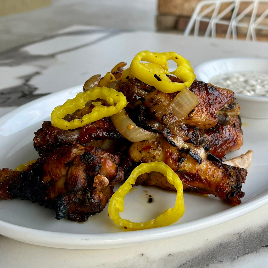 Photo of ZIMI Italian Famous ZIMI chicken wings, topped with banana peppers.